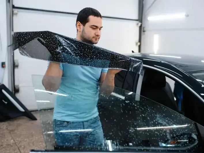 auto glass technician replacing cracked windshield for East Sammamish commuter vehicle